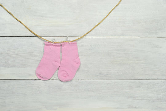 Baby concept. Baby socks composition on white wood background.