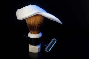 Brush with shaving foam shaving machine on black background