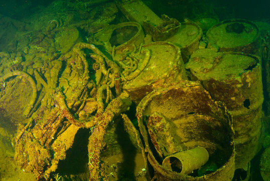 wreckage of oil barrels and other debris shot in the cargo hold of a sunken ship. The vessel that held this cargo was a second world war Japanese ship that was sunk in Chuuk Lagoon during conflict