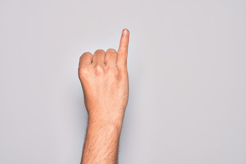 Hand of caucasian young man showing fingers over isolated white background showing little finger as pinky promise commitment, number one