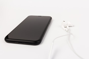Creative flat lay photo of workspace desk with earphones and mobile phone