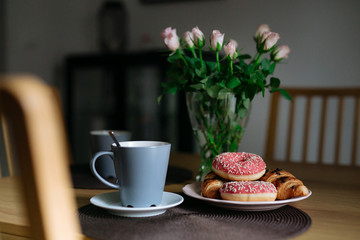 Croissants, flowers, and morning coffee in the kitchen