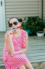 Girl Sitting on a Front Porch Eating a Popsicle