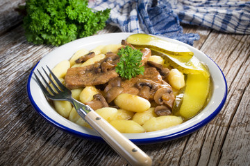 Braised pork loin with mushrooms.