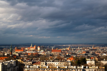 Naklejka na ściany i meble Panoramic view of Old City in Cracow a winter cloudy day with sunlight from the hill of Krakus Mound