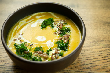 Pumpkin and kale cream soup with sweet cream