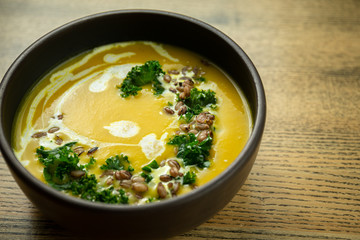 Pumpkin and kale cream soup with sweet cream