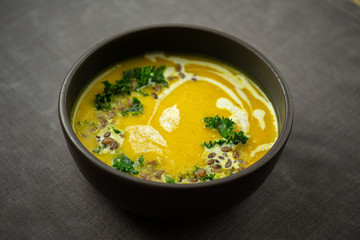 Pumpkin and kale cream soup with sweet cream