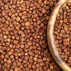 Gray peas background and wooden round bowl. Legumes bean seed. Healthy food. Natural organic grain.