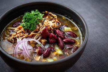 Bean soup with smoked pork, potatoes, herbs, onion