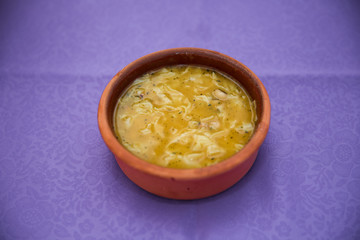 purple backgrounds . Erishde dish, eggplant stuffed dish and cucumber, tomato salad . Kesme, egg noodle , Kyrgyz, Azerbaijan cuisine, Traditional assorted dishes, Top view.