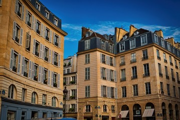 Fototapeta na wymiar Paris buildings. Old Paris architecture, beautiful facade, typical french houses on sunny day. Famous travel destinations in Europe.