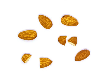 A close up of almond seeds on white isolated background. food and kitchen concept top view layout.