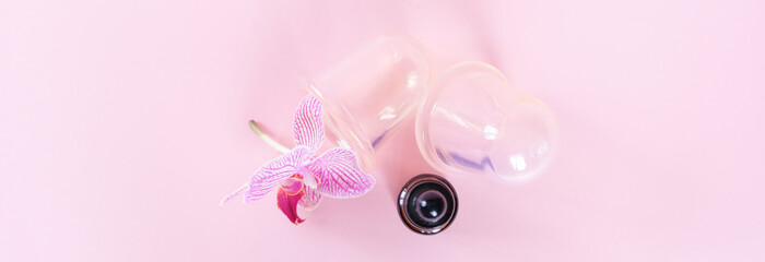 Vacuum cans for body on pink background. Rubber equipment for anti cellulite massage.