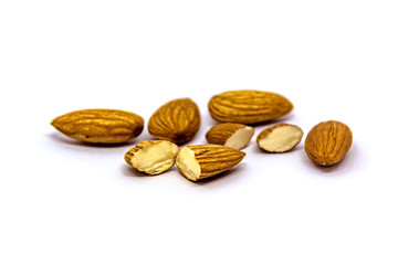 A close up of almond seeds on white isolated background. food and kitchen concept.