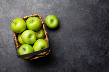 Ripe green apple fruits on dark stone table