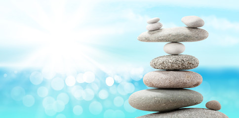 Pyramid of sea pebbles on a sunny beach