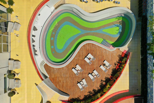 Aerial drone top down photo of minimalist design pop art colour pool