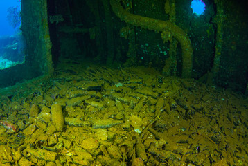 The floor in a sunken ship called the Fujikawa Maru is lined with bottles of Sake. The vessel that held this cargo was a second world war Japanese ship that was sunk in Chuuk Lagoon during conflict - 341026832
