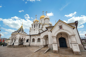 Fototapeta na wymiar Zachatyevsky Monastery Katholikon in Ostozhenka district, Moscow, Russia. Nativity of Virgin Mary Cathedral. Orthodox church and blue cloudy sky. 