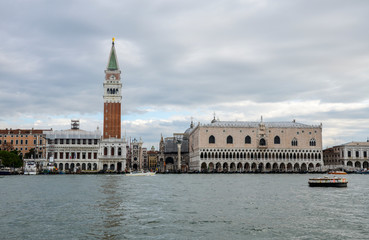 Fototapeta na wymiar Beautiful view of Venice with Campanile tower of Saint Mark's Cathedral, Basilica on San Marco square and old Doge's palace. Famous romantic panorama of seafront city on water.