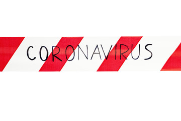Red and white warning tape with the inscription coronavirus close up on an isolated white...