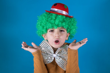 Little kid with clown costume isolated in blue