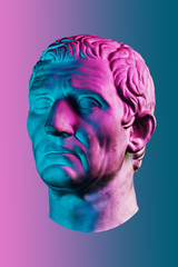 Statue of Guy Julius Caesar Octavian Augustus. Creative concept colorful neon image with ancient roman sculpture Guy Julius Caesar Octavian Augustus head. Cyberpunk, vaporwave and surreal art style.