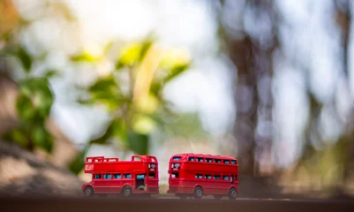 Foto op Plexiglas toys that represent two of the main symbols of the city of London, double-decker bus on blurred background. selective focus and grain nose. © stockchalathan