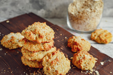 Oatmeal cookies on a wooden background. Close-up. Free space for text. Healthy homemade cookies. Sweet pastries. A stack of oatmeal cookies with coconut
