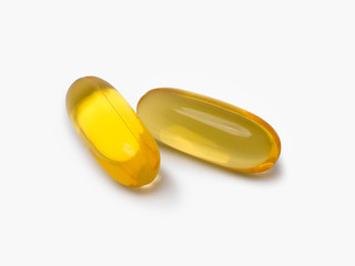 Two Omega 3 Fish Oil supplement Capsule, isolated against a white background with room for text