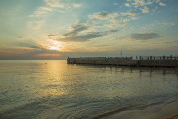 Sunset on the Mediterranean sea. Silhouettes of fishermen on the breakwaters. Beautiful sunset on the beach . Fishermen by the sea at sunset . Beautiful embankment on the Caspian Sea in Baku .Sunset .