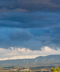 Distant view of a wind farm on a stormy spring afternoon