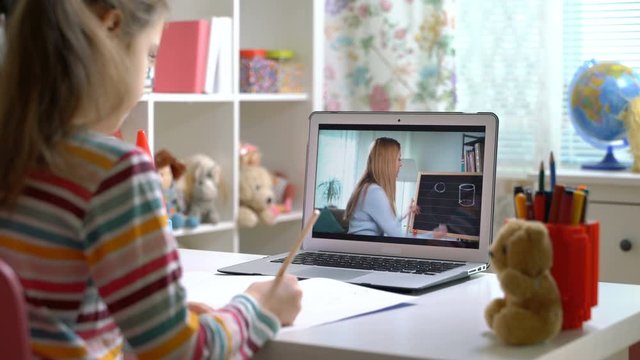 Young woman distance teacher online tutor conferencing on laptop communicate with pupil by webcam video call e-learning. Home quarantine distance learning and working at home.