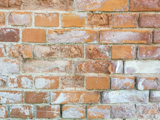 Background texture old red weathered brick wall with damage and white light spots
