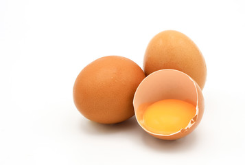 Chicken eggs and broken egg with yolk isolated on white background.