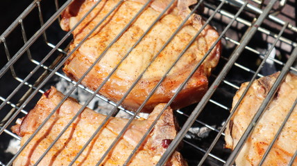 Pork steaks cooked on a charcoal grill outdoors