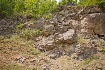 Green forest . rocky path through the mountains . rocky wall of a peak mountain . beautiful rocky mountain and greenery pasture . Rocky mountains by the road.