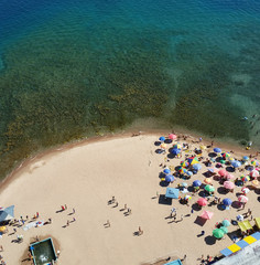 Aerial shot of the people enjoying on the coast of Issyk-Kul lake on a sunny day