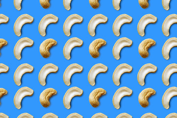 Cashew nuts seamless pattern on a blue background. Food cashew nuts pattern. Food pattern.