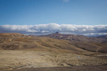 desert-mountainous terrain . Blue sky with many white clouds. Desert and Mountain Landscape with Azerbaijan . Desert and blue sky with white clouds. Big yellow sand, desert and blue sky. Nature .