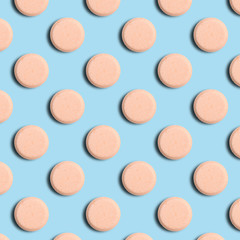 Seamless pattern of pharmaceutical pills or vitamins on a blue background. Orange pills on a blue background.