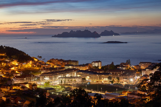 Sunset view of the city of Baiona with the silhouette in the background of the Cies islands in Galicia, Spain.