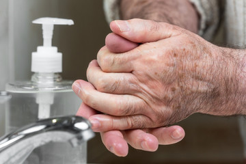 Elderly people ,using alcohol antiseptic gel ,prevent infection,outbreak of Covid-19. Senior man washing hand with hand sanitizer to avoid contaminating with Coronavirus .