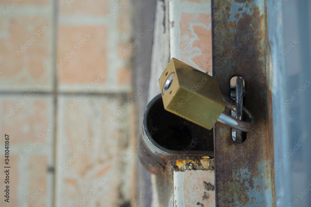 Wall mural master key on old iron gate background.