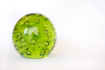 A green crystal ball with bubbles inside, isolated on white background.