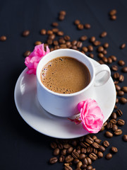 white espresso Cup and pink flowers on the table