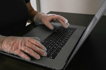 Fototapeta na wymiar Woman protected with gloves against coronavirus, covid-19 or any other disease, working from home