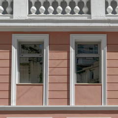 Fototapeta premium modern interpratation of classic building design with pink wall and white frame openings