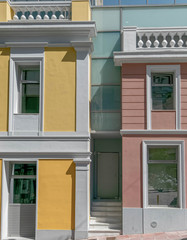 modern interpratation of classic building design with pink and yellow wall and white frame openings